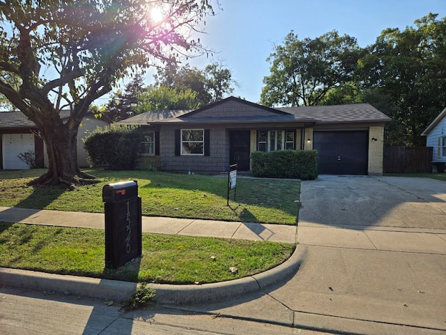 ranch-style home featuring a garage and a front lawn