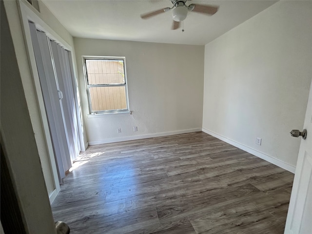 unfurnished bedroom with dark hardwood / wood-style floors and ceiling fan