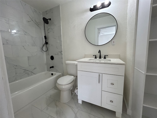 full bathroom featuring tiled shower / bath, vanity, and toilet