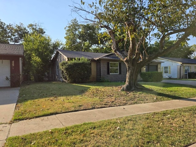 single story home with a front yard and a garage