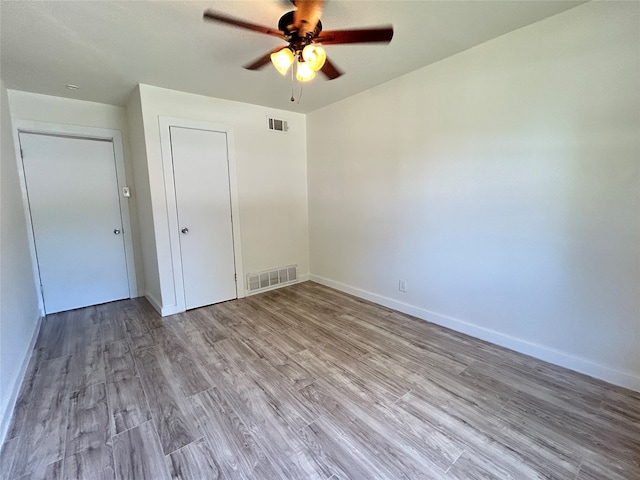 unfurnished bedroom with light hardwood / wood-style floors and ceiling fan