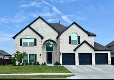 french country home with a front lawn and a garage