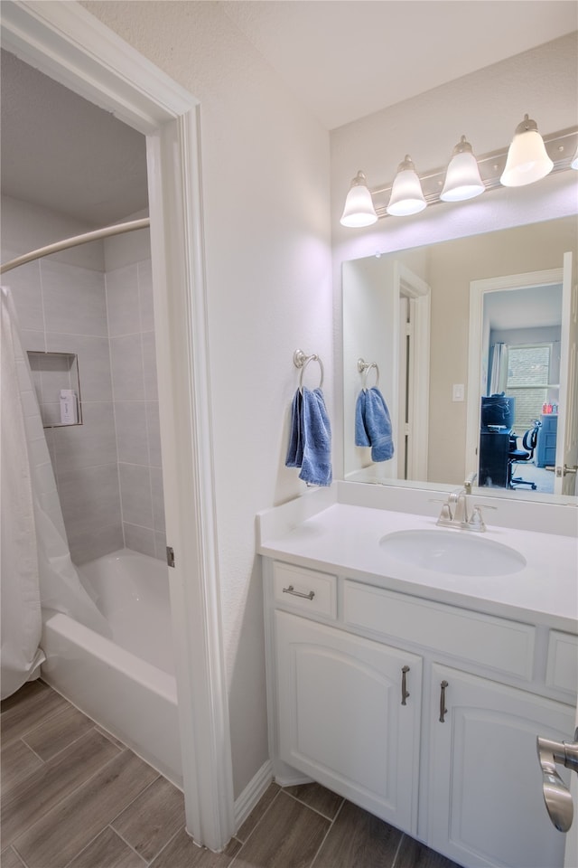 bathroom featuring wood-type flooring, vanity, and shower / bath combination with curtain