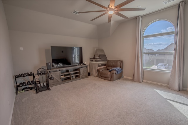 living area with lofted ceiling, ceiling fan, and light colored carpet