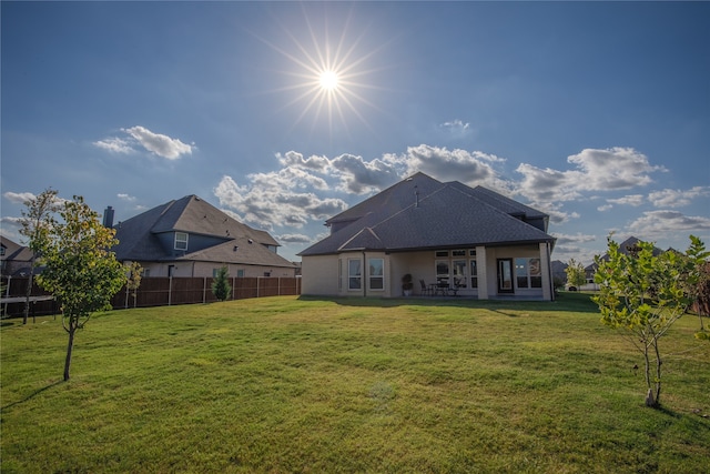 rear view of house with a lawn