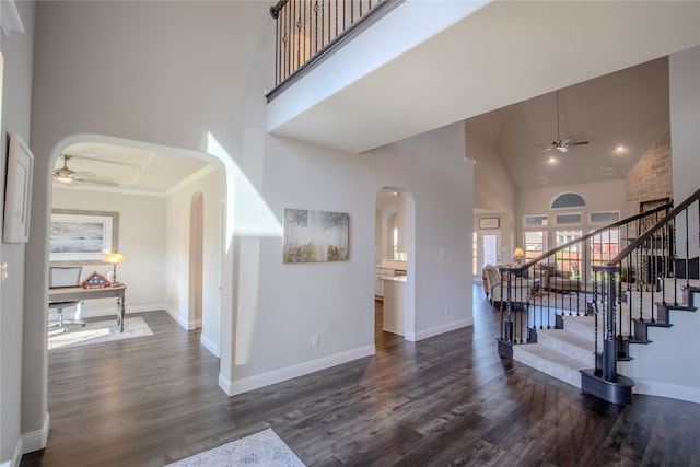 foyer featuring ceiling fan, dark wood-type flooring, and high vaulted ceiling