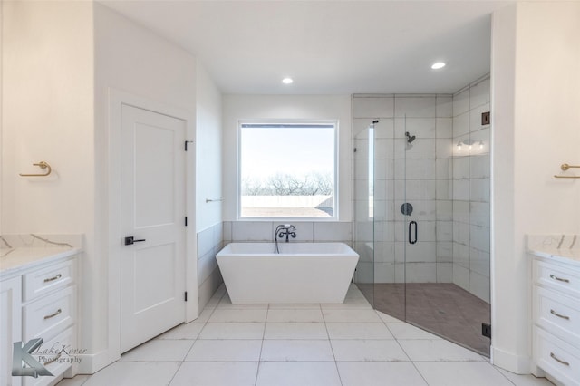 full bathroom featuring recessed lighting, a soaking tub, a shower stall, and vanity