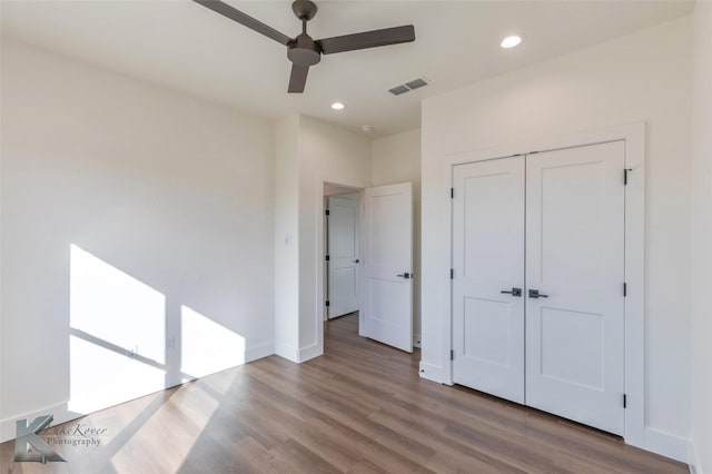 unfurnished bedroom featuring light wood finished floors, baseboards, visible vents, and recessed lighting