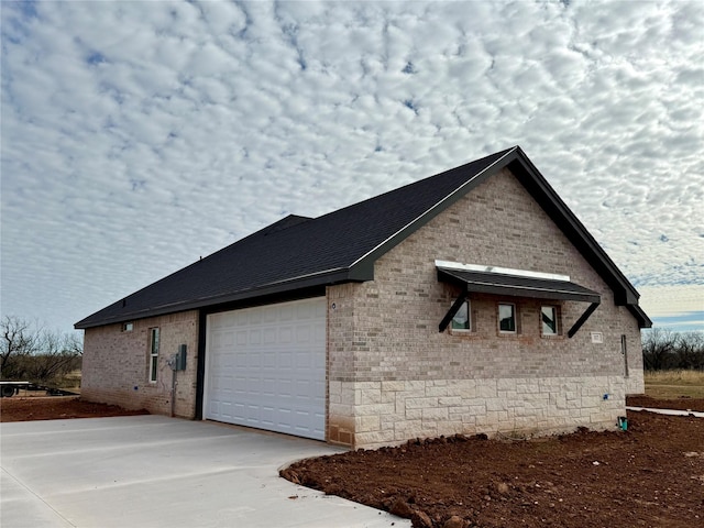 view of side of property with a garage