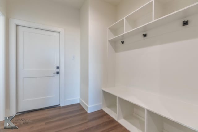 mudroom featuring baseboards and dark wood-style floors