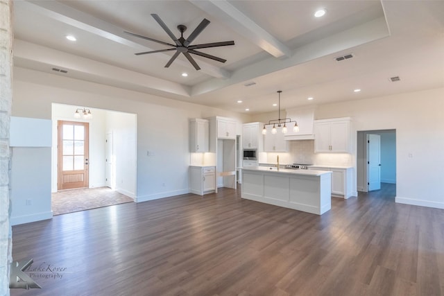 kitchen featuring visible vents, a kitchen island with sink, white cabinetry, and open floor plan