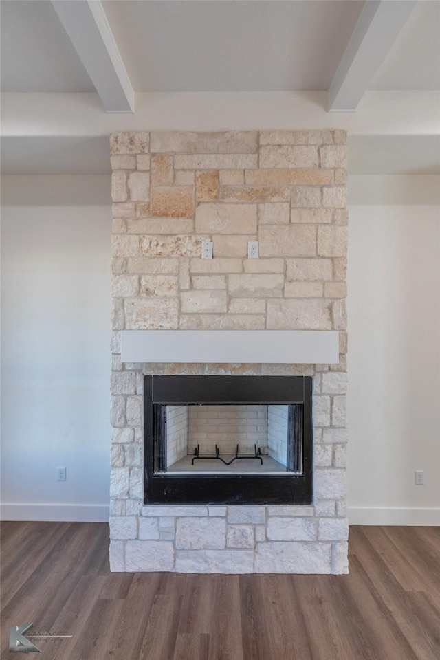 room details featuring a fireplace, wood finished floors, and beam ceiling