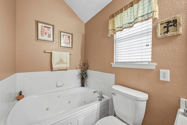 bathroom with vaulted ceiling, a textured ceiling, a washtub, and toilet