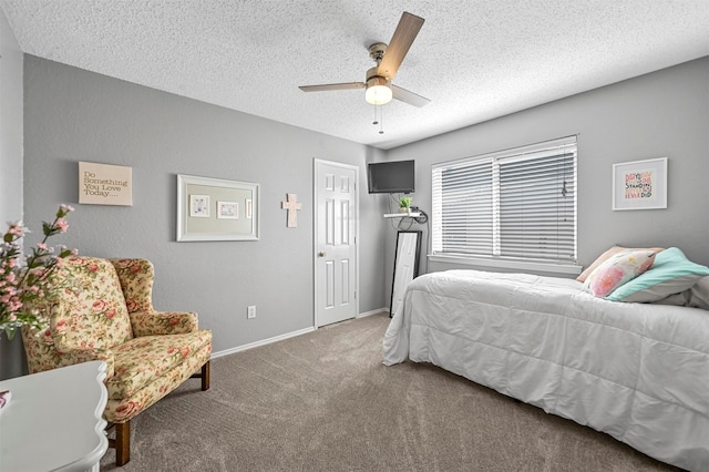 bedroom with ceiling fan, a textured ceiling, and carpet flooring