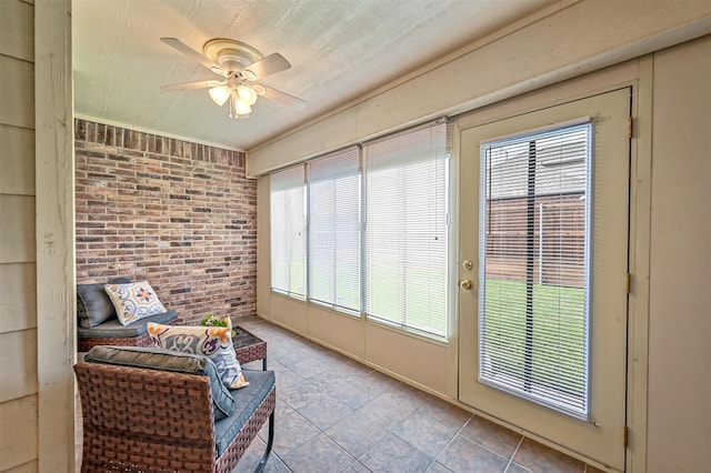 sunroom featuring ceiling fan