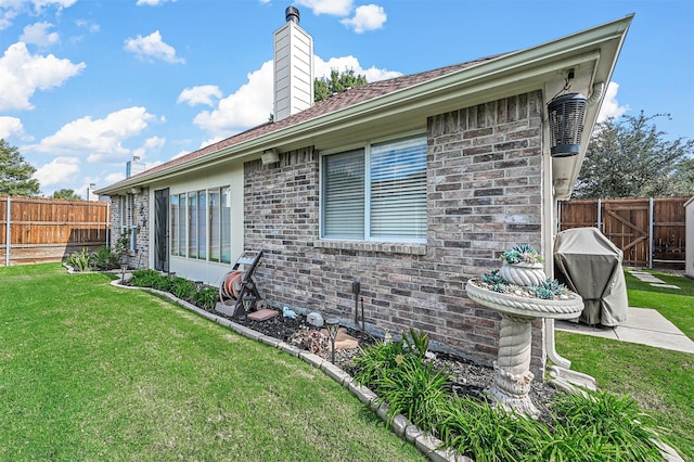 view of home's exterior with a lawn