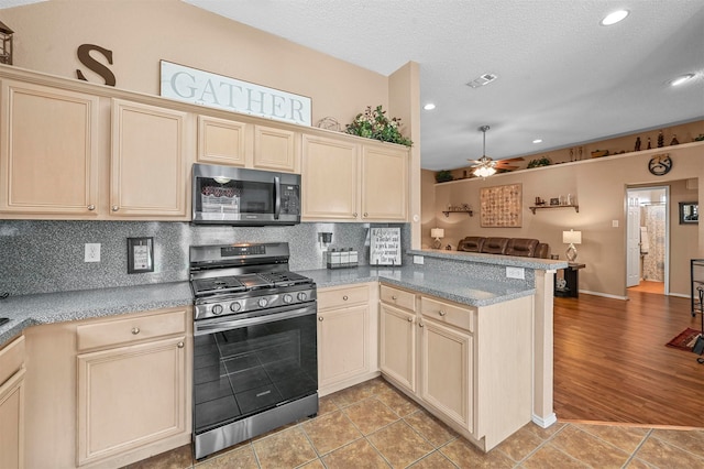 kitchen with light hardwood / wood-style floors, kitchen peninsula, decorative backsplash, stainless steel appliances, and ceiling fan