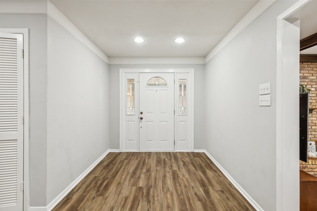 foyer entrance featuring dark hardwood / wood-style floors and ornamental molding