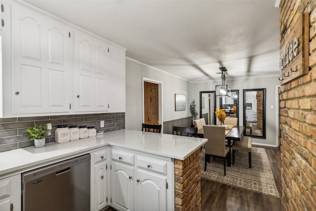 kitchen with white cabinetry, dishwasher, dark hardwood / wood-style flooring, kitchen peninsula, and pendant lighting