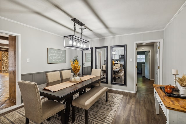 dining area with dark hardwood / wood-style floors and ornamental molding