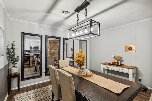 dining area featuring dark hardwood / wood-style floors and ornamental molding