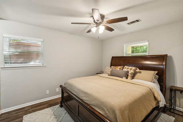 bedroom with ceiling fan and dark wood-type flooring