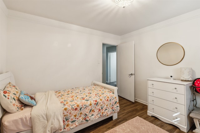 bedroom featuring dark hardwood / wood-style flooring and crown molding