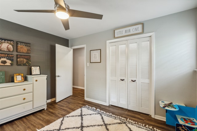 bedroom featuring ceiling fan, dark wood-type flooring, and a closet