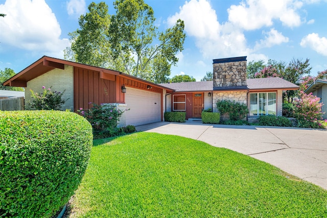 single story home featuring a garage and a front yard