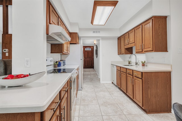 kitchen with light tile patterned floors, sink, and white appliances