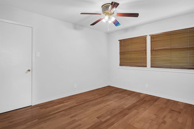 empty room with ceiling fan and hardwood / wood-style flooring