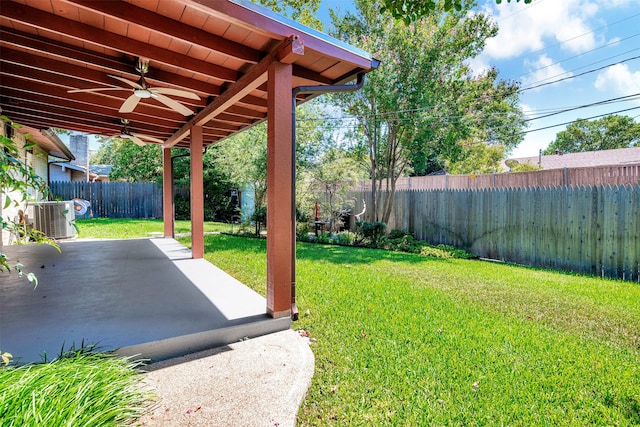 view of yard with a patio, ceiling fan, and central AC unit