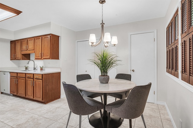 dining room with light tile patterned flooring, sink, and a chandelier