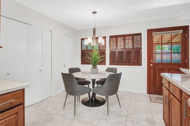 tiled dining space with a chandelier