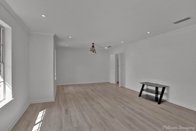 unfurnished room featuring ornamental molding and light hardwood / wood-style floors