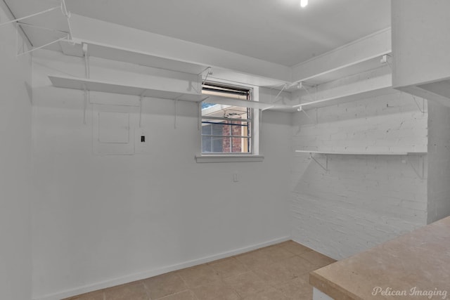 spacious closet featuring light tile patterned flooring and electric panel