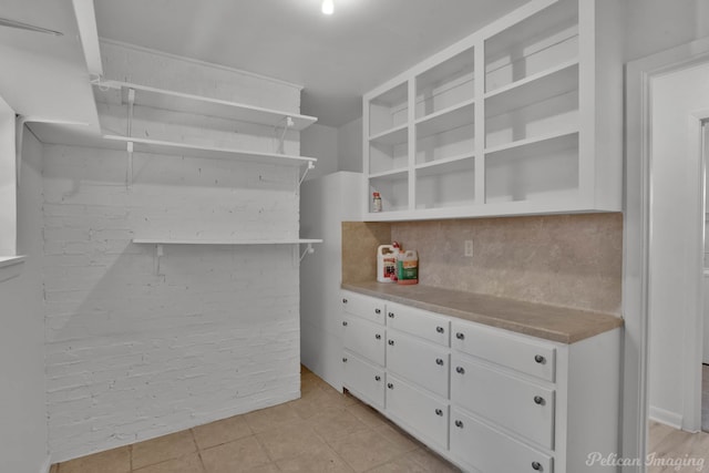 walk in closet featuring light tile patterned flooring