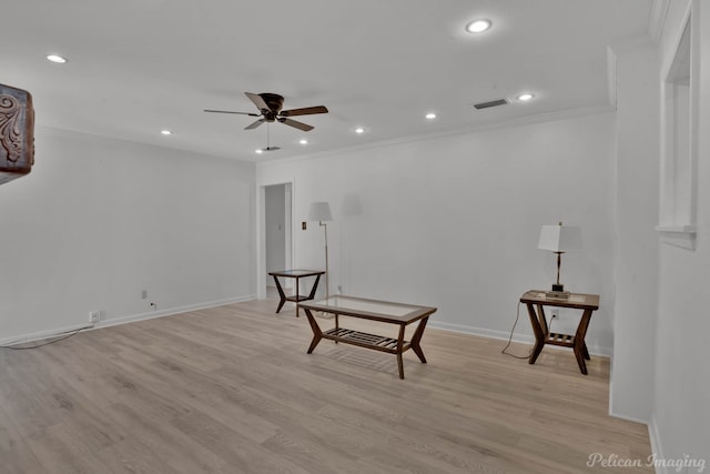 sitting room with light hardwood / wood-style floors, crown molding, and ceiling fan