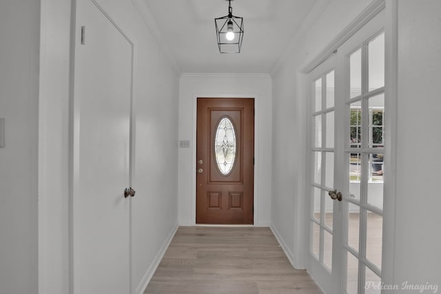 doorway with french doors, crown molding, and light hardwood / wood-style flooring