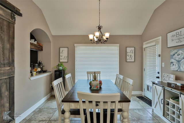 dining space with a barn door, light tile patterned flooring, vaulted ceiling, and an inviting chandelier