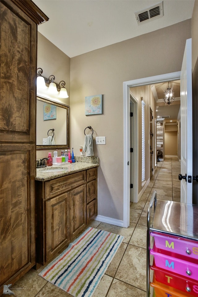 bathroom featuring vanity and a notable chandelier