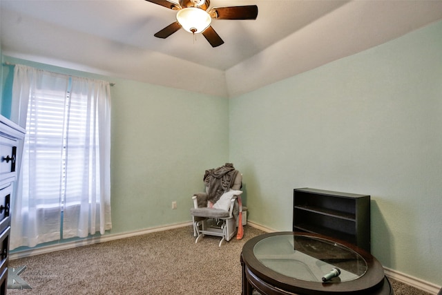 living area featuring ceiling fan, vaulted ceiling, and carpet