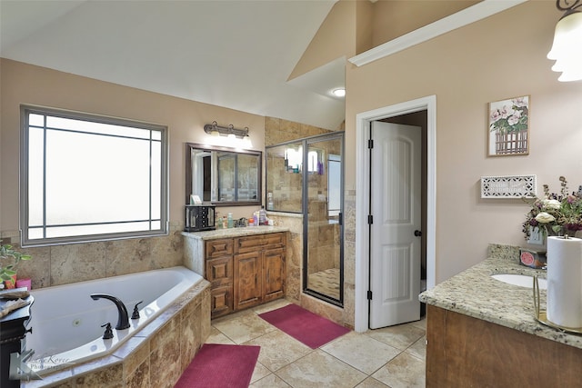 bathroom featuring vanity, shower with separate bathtub, vaulted ceiling, and tile patterned floors