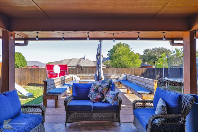 view of patio with a trampoline and an outdoor living space