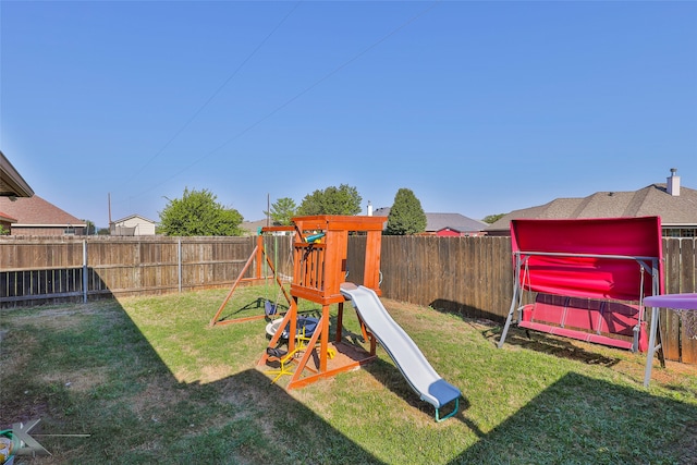 view of playground with a lawn