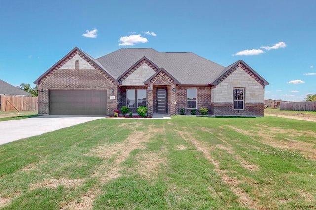 view of front of house featuring a front lawn and a garage