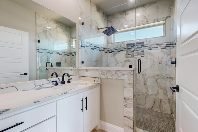 bathroom featuring walk in shower and vanity