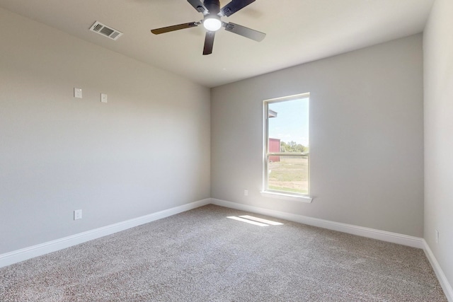 unfurnished room featuring ceiling fan and carpet