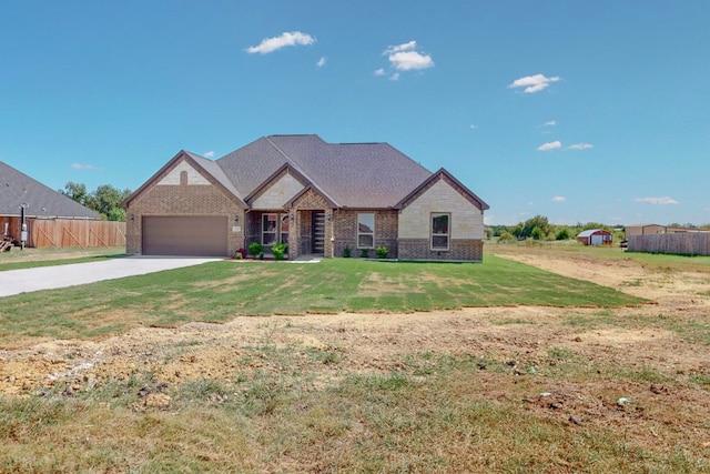 view of front of house with a front yard and a garage