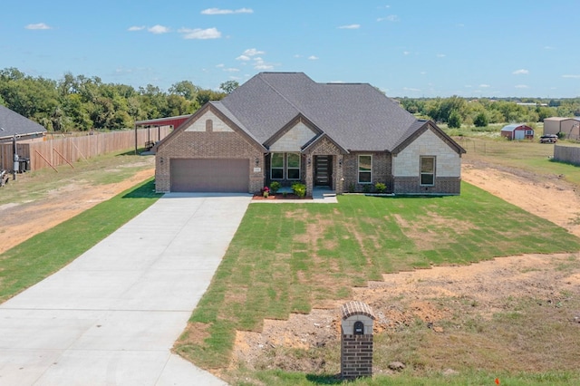 view of front of property featuring a garage and a front lawn